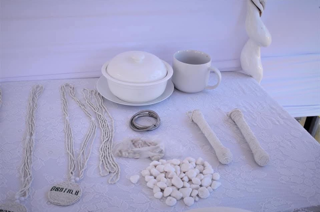 Sacred Obatala items including white eleke beads, ceremonial vessels, and sacred objects